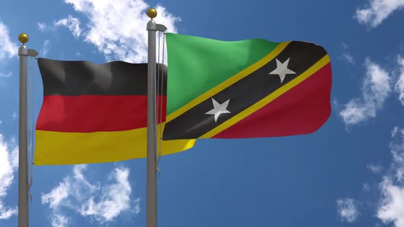 Germany Flag Vs Saint Kitts And Nevis On Flagpole