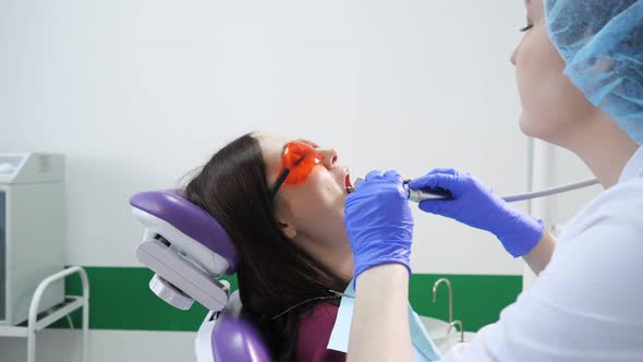 Young Woman on Preventive Examination in Dental Chair at the Dentist