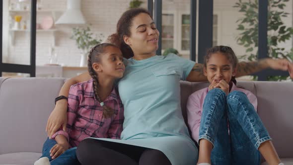 United Happy Family with Kids Embracing on Couch