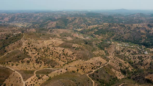 Vista Of Mountain Ranges With Dense Forest On A Misty Sky. - Aerial Drone