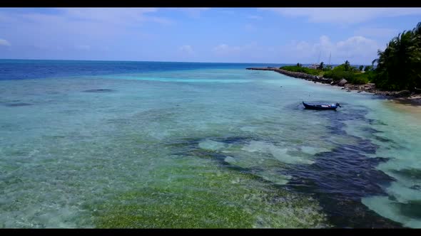 Aerial above seascape of perfect shore beach holiday by clear lagoon with white sandy background of 