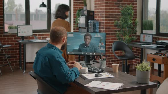 Entrepreneur Using Video Call Communication to Talk to Colleague