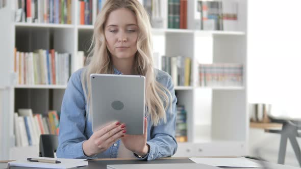 Young Woman Browsing Internet on Tablet