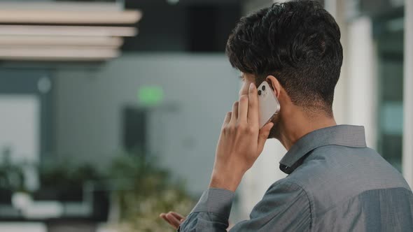 Back View of Indian Man Confident Arab Businessman Entrepreneur Calling Business Partner Talking