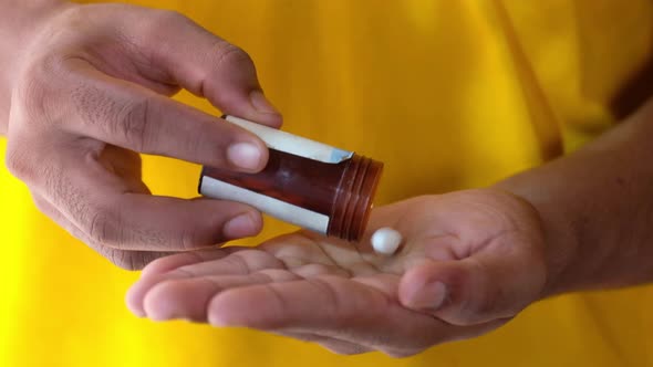 Close Up of Man Hand Taking Medicine 