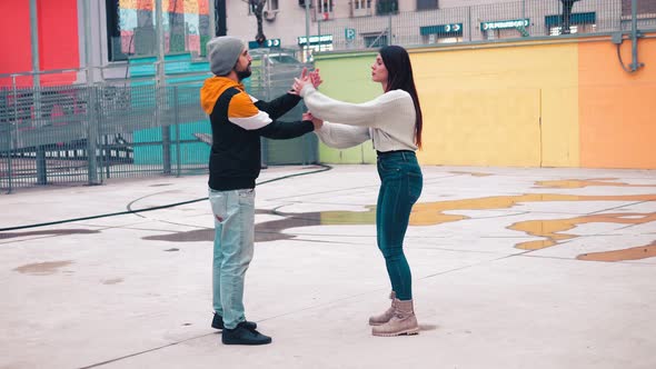 dance rehearsal - young woman teaches dance steps to her friend