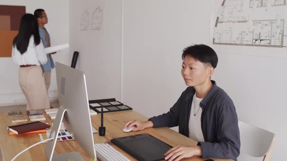 Female Asian Architect Working on Computer in Office