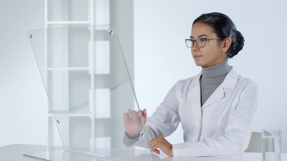 Female Doctor Working on Futuristic PC