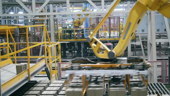Robotic Mechanism, Industrial Robot Is Relocating Freshly-made Bricks From Conveyor.