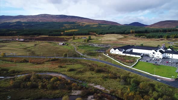 Aerial Panning of a Distillery and Farmland in Dalwhinnie Scotland