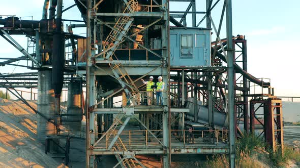 Mining Construction in the Port with Two Engineers Standing in It