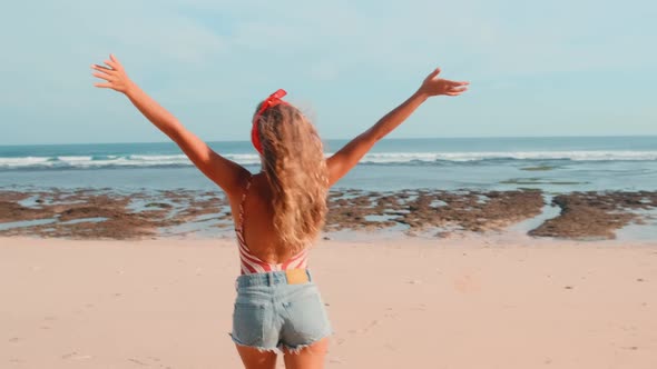 Young Caucasian Woman Runs Along Sea Beach Rejoicing at Longawaited Travel