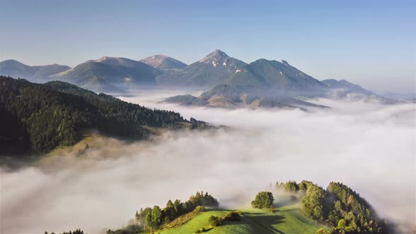 Aerial View of Foggy Clouds in Green Mountains