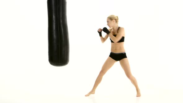 Intensive Training with a Punching Bag Girl Boxer, White Studio