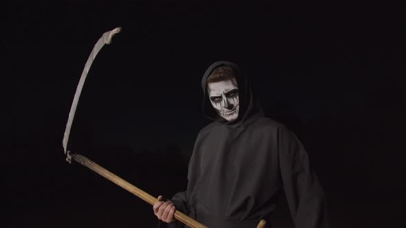 Scary Death Holding Scythe on Halloween Night
