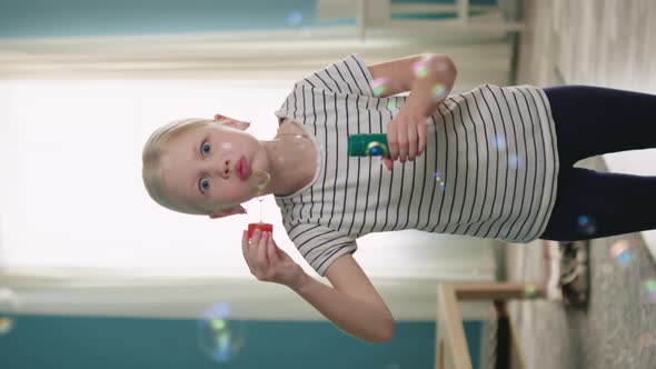 Funny Blonde Girl Is Blowing Bubbles