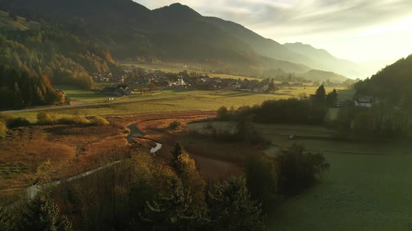 Flying over autumn landscape at sunrise