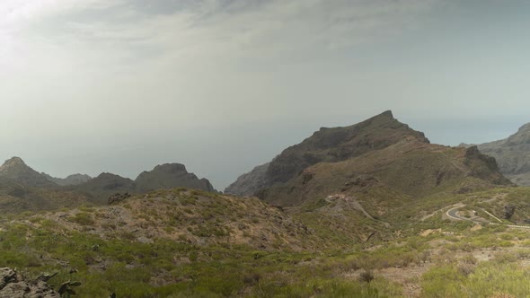 Coastal mountain range in Tenerife island while cloudscape rolling over, timelapse