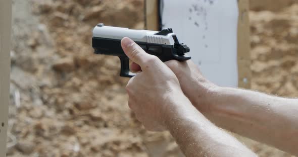 Pistol shooting bullets in slow motion footage. Hand guns in firing range