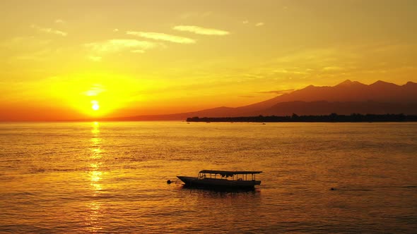 astonishing golden tropical seascape, majestic sunset over the boats floating in the calm seawater