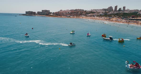 Drone Following Water Scooter That Approaches to the Beach Motor Boat at Summer