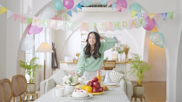 Asian girl preparing the dining table for the birthday party