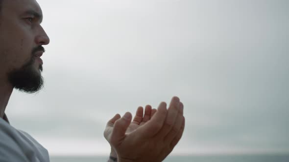 Athletic Man Making Hands Exercises Practicing Karate on Nature Close Up