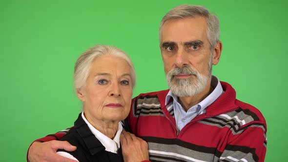 An Elderly Couple Looks Seriously at the Camera - Closeup - Green Screen Studio