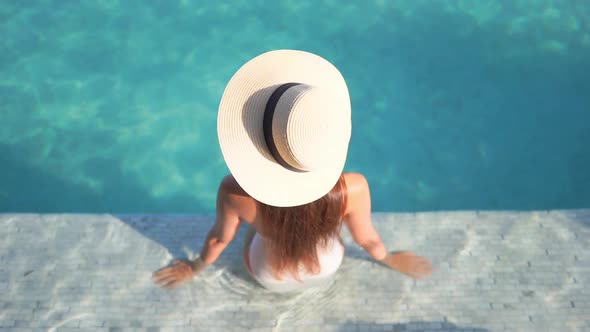 Young asian woman enjoy around outdoor swimming pool for leisure