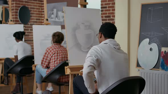 African American Student Drawing Vase Model in Art Class