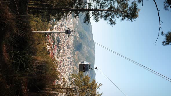 Cable car cabins moving up and down, vertical video.