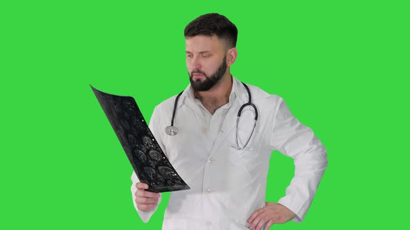 Doctor From Middle East Walking and Looking at Ct Scan on a Green Screen, Chroma Key.