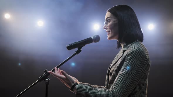 The Female Financial Coach Emotional Gesturing Talks From the Stage with Spectators at Forum. Too