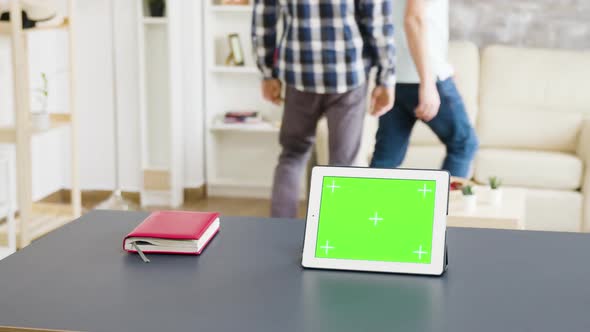 Medium Shot of Tablet with Green Screen on the Table