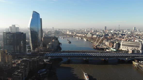 Panoramic aerial view of Blackfriars train station over river Thames on a hazy sunny day