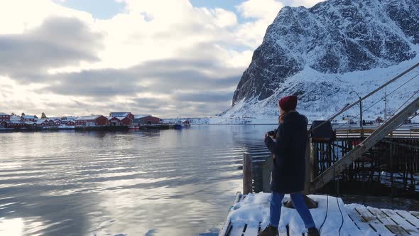 Girl Taking A Photo Of Evening Winter Sea Bay