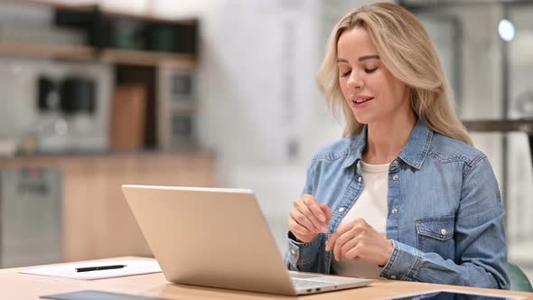 Online Video Chat on Laptop By Young Woman at Work