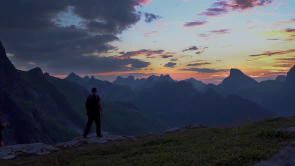 A Man and a Woman Travel in the Mountains Early in the Morning