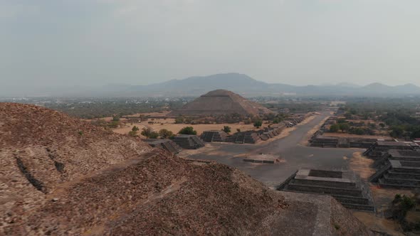 Fly Around Top of Pyramid of the Moon Revealing Long Historic Street with Archaeological Landmarks