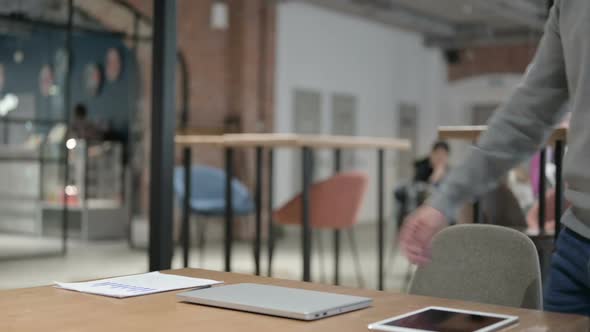 Young Man Opening Laptop While Sitting in Office