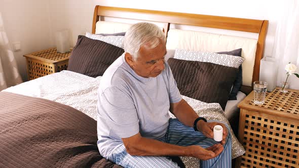 Senior man taking medicines