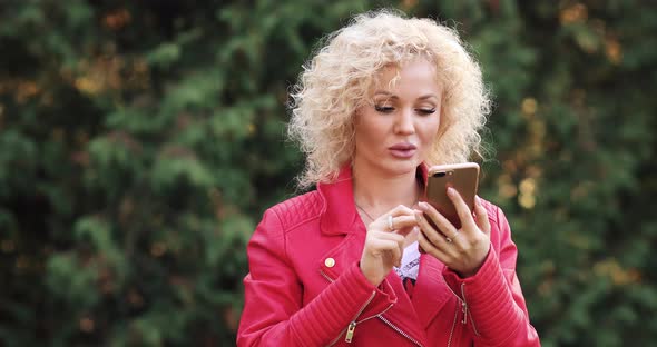 Blonde in Looking at Phone, Getting Message and Laughing