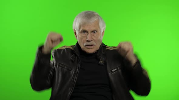Elderly Caucasian Grandfather Rocker Man Shows Fist Fight. Chroma Key Background