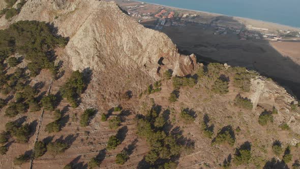 Aerial close shot tilt up Volcanic summit scene, Porto Santo island