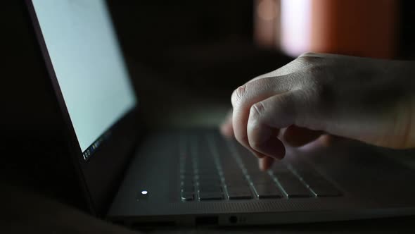 Extreme close up woman hands using notebook at night