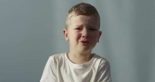 Portrait Of A Little Boy Crying Indoors Shot On Red Camera