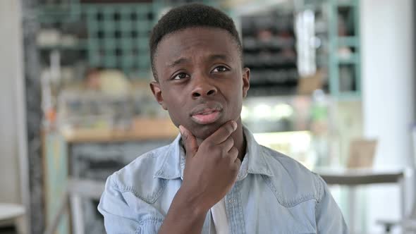 Portrait of Pensive Young African Man Thinking of New Idea