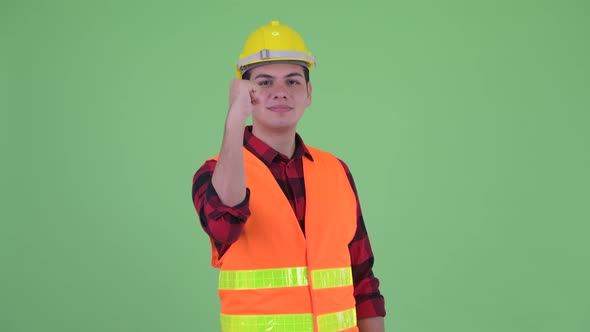 Happy Young Multi Ethnic Man Construction Worker with Fist Raised