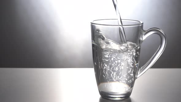 Pour Water Into a Glass Mug