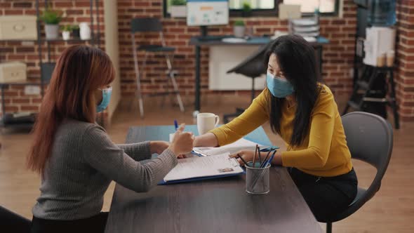 Job Candidate Signing Recruitment Documents at Interview Meeting